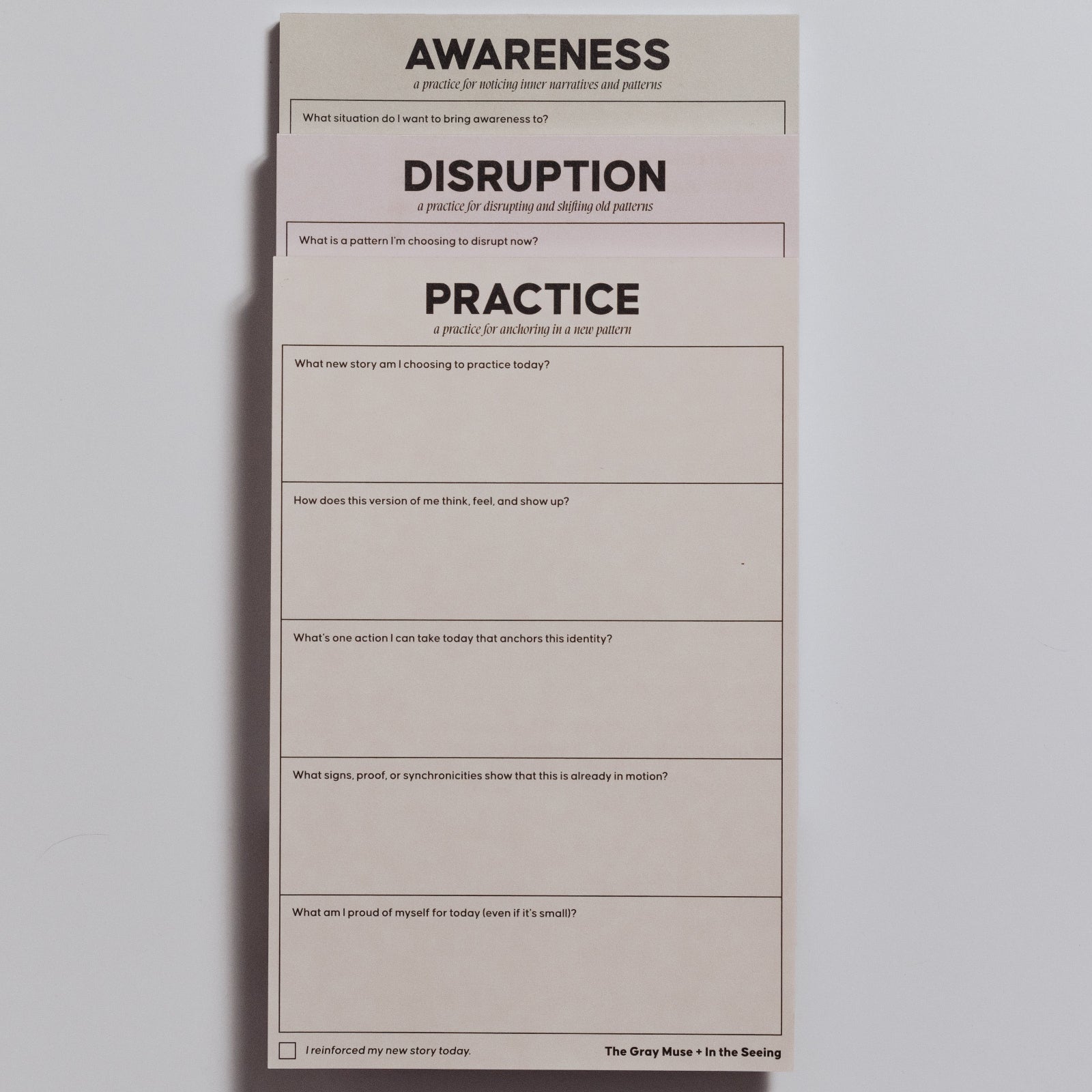 Three half letter notepads stacked with bold titles Awareness Disruption and Practice for personal growth