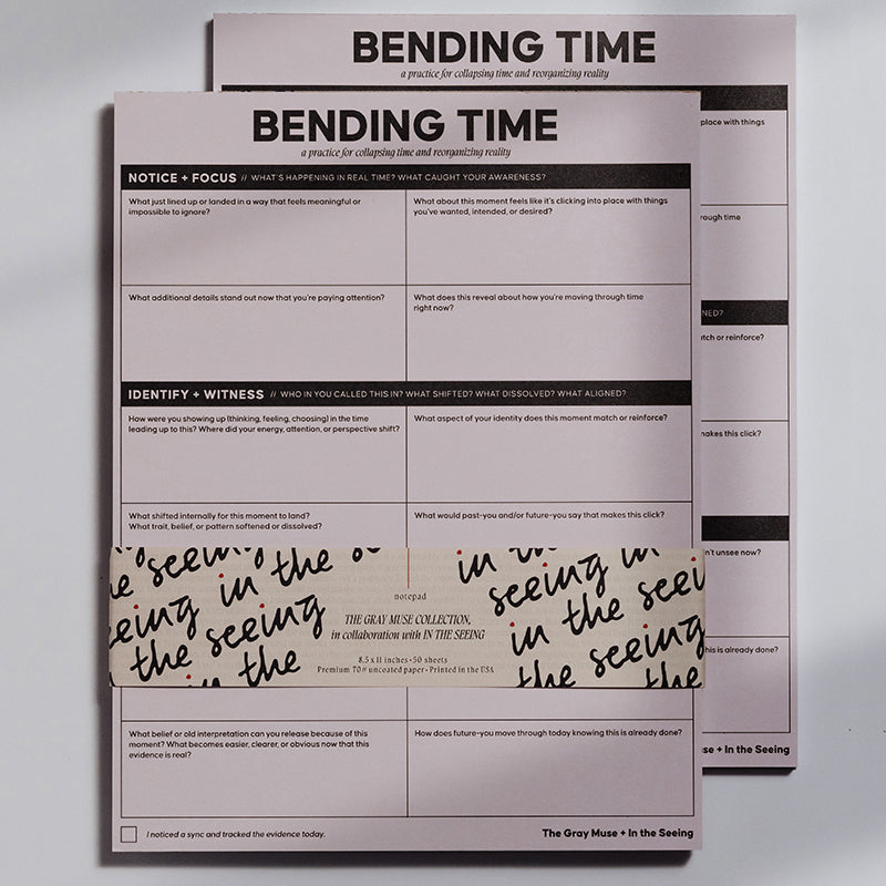 Two pink Bending Time Notepad booklets stacked with bold BENDING TIME title and grid prompts for reflection