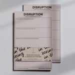 Front view of two pink Awareness Disruption Practice notepads, with one page labeled DISRUPTION and a wraparound bundle.