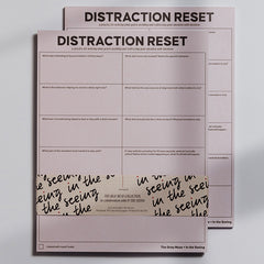 Two pink Distraction Reset Notepads stacked with bold DISTRACTION RESET header