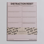 Distraction Reset Notepad in soft pink with a two column grid of prompts for refocusing