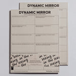 Dynamic Mirror Notepad on a light surface with a second sheet behind and the bold title at the top