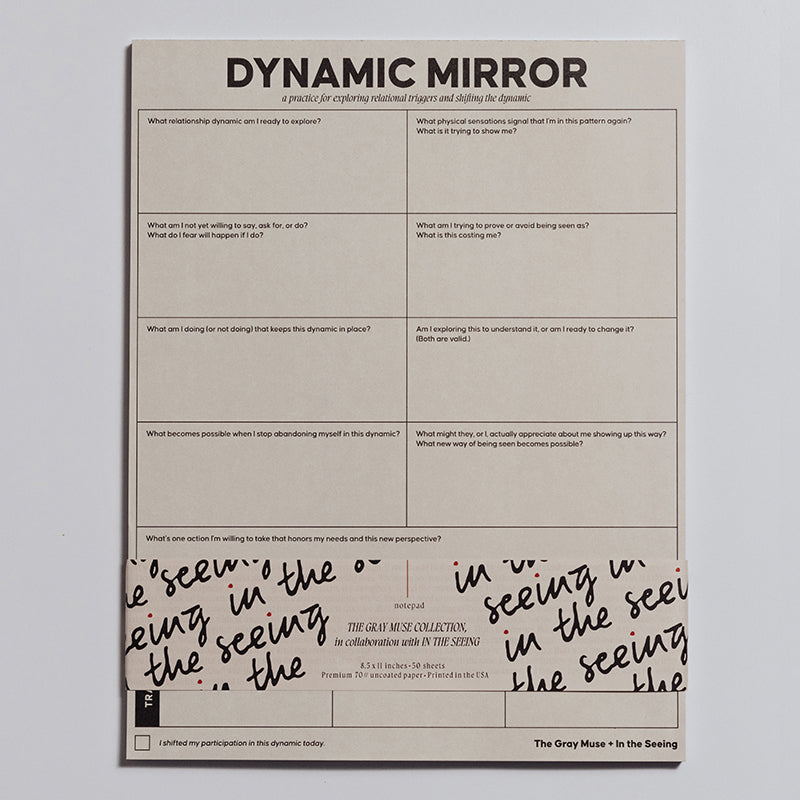 Dynamic Mirror Notepad cropped on a light background with visible grid prompts and decorative bottom packaging