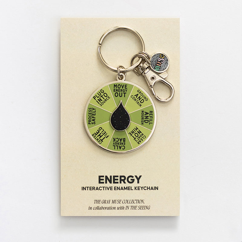 Beige card for Energy Spinner Interactive Enamel Keychain with a green segmented wheel, black center, and small charm.