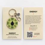 Energy Spinner interactive enamel keychain with a green segmented wheel and black drop center on a beige display card