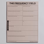 The Frequency Field Notepad displayed upright with a decorative wrap around the lower portion.