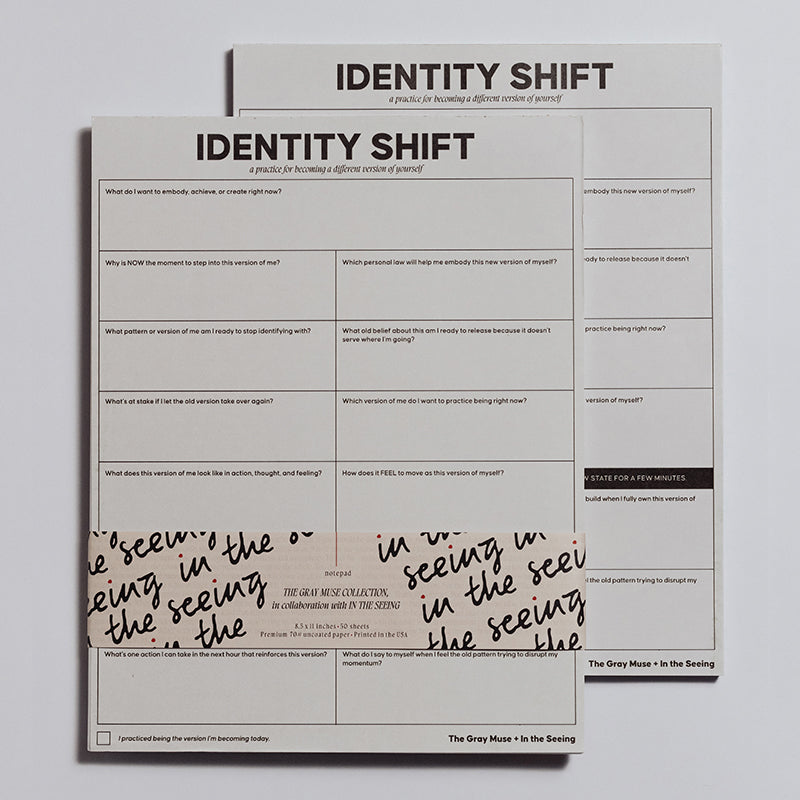 Identity Shift Notepad with bold title and a two column grid of prompts on white sheets wrapped by a decorative band