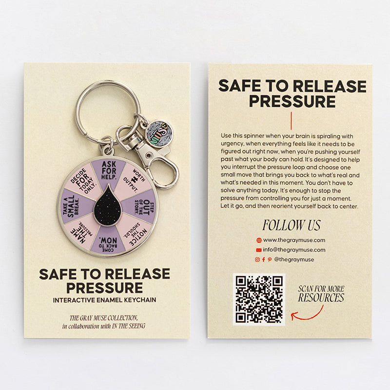 Two panel display featuring a round lavender spinner enamel keychain with a black teardrop center on a beige card