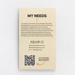 Back side of My Needs packaging features descriptive text followed by a QR code.