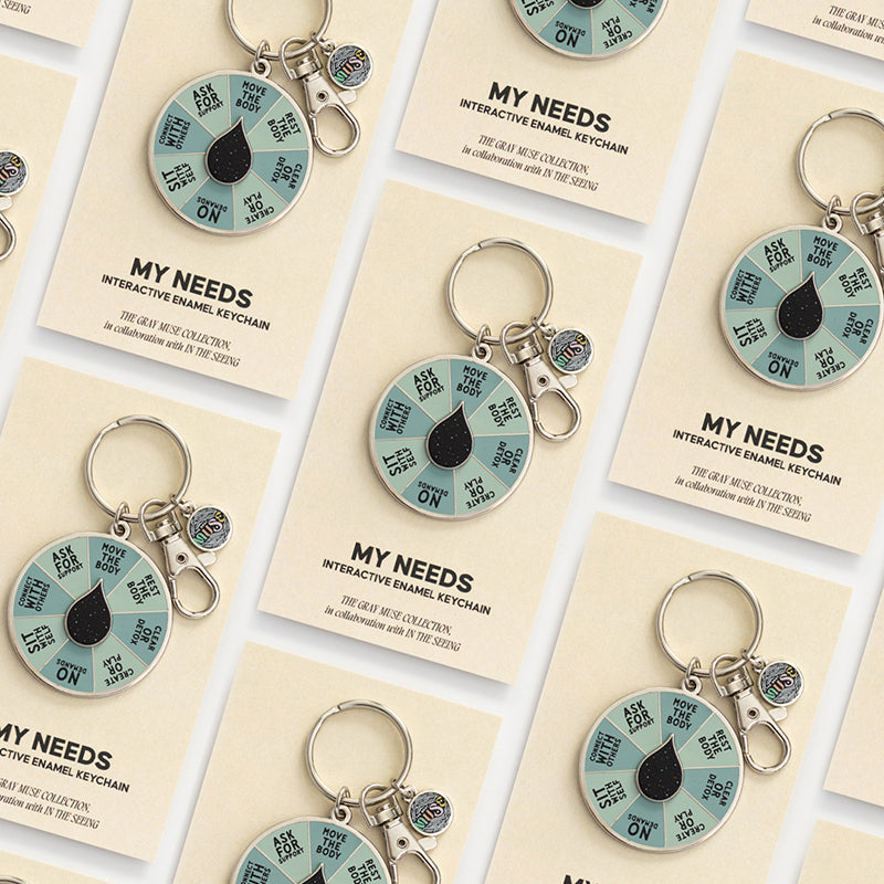 Collage of multiple My Needs spinner keychain cards arranged in a grid with teal spinners visible.