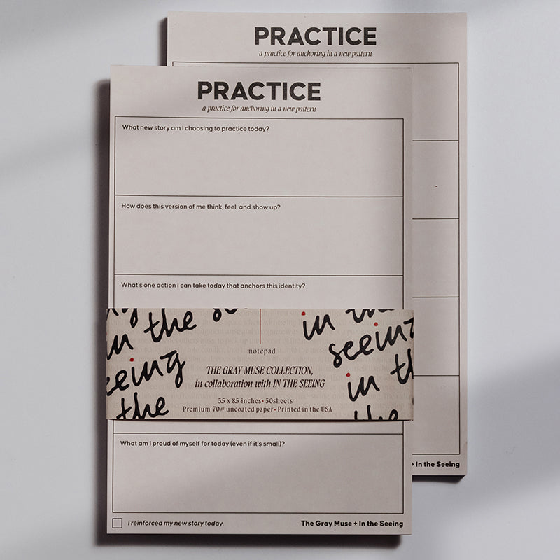 Two half letter size notepads from the set stacked together with the top one titled PRACTICE in a soft pink finish.