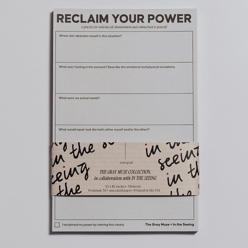 Reclaim Your Power Notepad partially wrapped in a decorative band with branding visible.