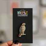 Red-Tailed Hawk enamel pin displayed on a black card with The Gray Muse logo