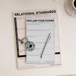 Staying with Yourself Bundle arranged with Relational Standards Notepad Reclaim Your Power Notepad a teal My Needs Spinner and a decorative wrap on a light surface.