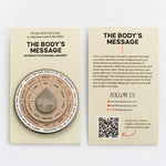 The Body's Message interactive enamel magnet shown with beige information card.